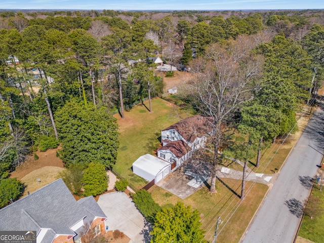 drone / aerial view featuring a wooded view