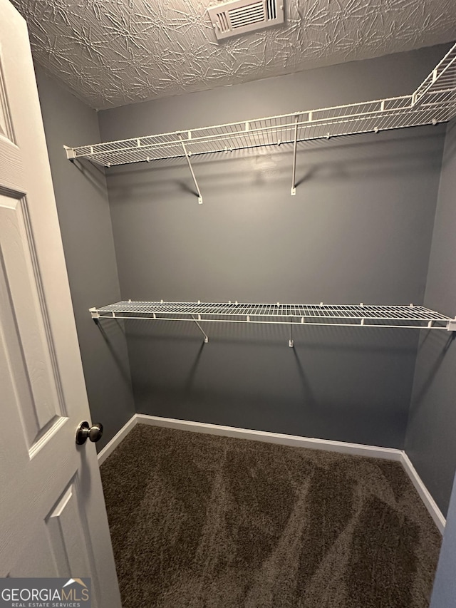 walk in closet with carpet and visible vents