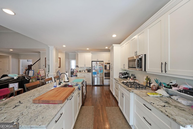 kitchen featuring tasteful backsplash, dark wood-style floors, white cabinetry, recessed lighting, and appliances with stainless steel finishes