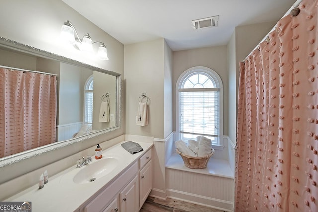 bathroom featuring visible vents, wood finished floors, and vanity