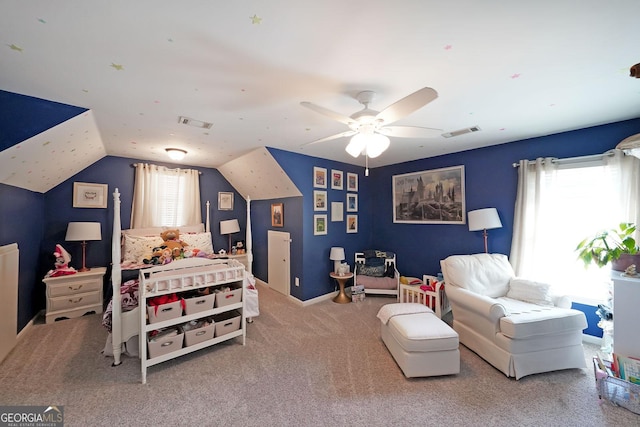 carpeted bedroom with visible vents, multiple windows, and vaulted ceiling