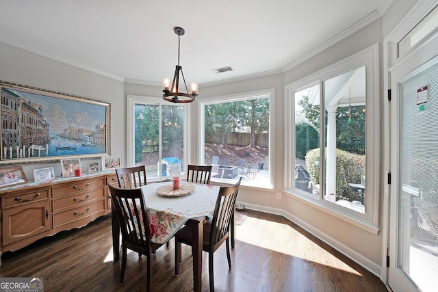 dining room featuring visible vents, baseboards, dark wood finished floors, ornamental molding, and a notable chandelier