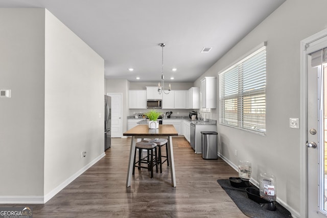 kitchen featuring recessed lighting, stainless steel appliances, baseboards, white cabinets, and dark wood finished floors