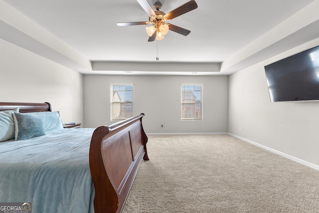 carpeted bedroom featuring a ceiling fan and baseboards