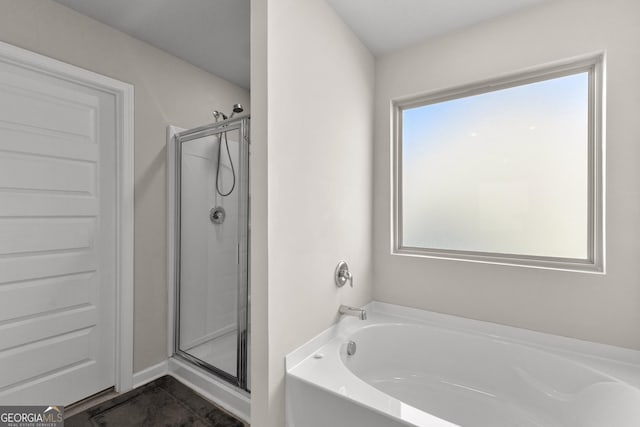 bathroom with a garden tub and a shower stall