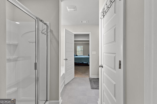 ensuite bathroom with a stall shower, baseboards, visible vents, and ensuite bathroom