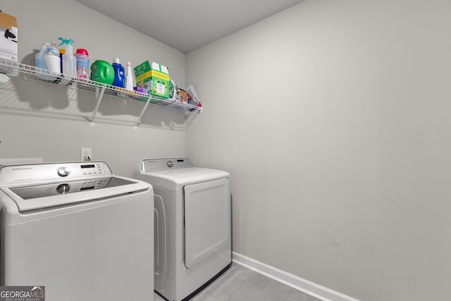 laundry area featuring laundry area, independent washer and dryer, and baseboards