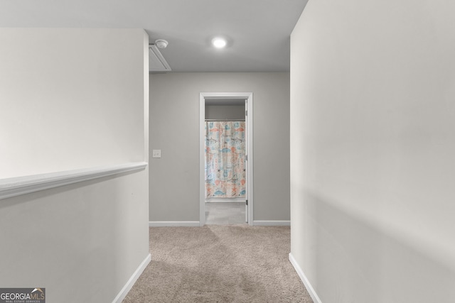 corridor with carpet floors and baseboards