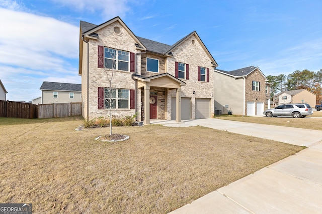 traditional home with an attached garage, brick siding, fence, driveway, and a front yard