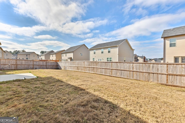 view of yard with a residential view and a fenced backyard