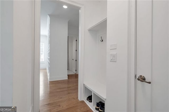 mudroom featuring light wood-style flooring and baseboards