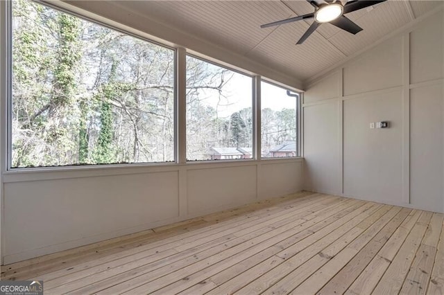 unfurnished sunroom with a ceiling fan and lofted ceiling