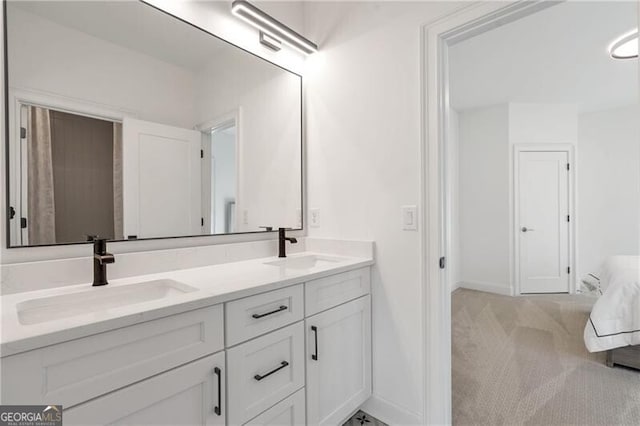 full bath featuring double vanity, a sink, and baseboards