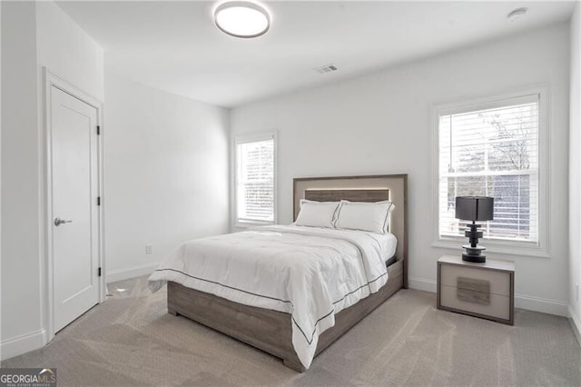 bedroom with baseboards, visible vents, and carpet flooring