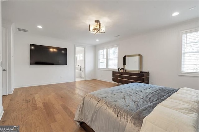 bedroom with multiple windows, visible vents, wood finished floors, and recessed lighting