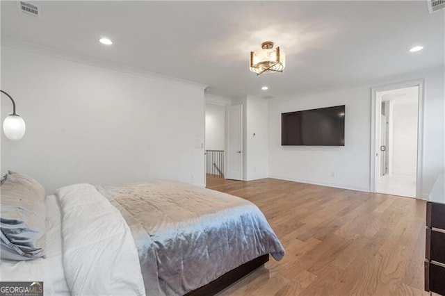 bedroom with recessed lighting, visible vents, crown molding, and wood finished floors