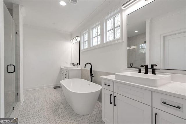 full bath featuring ornamental molding, a stall shower, a soaking tub, and a sink