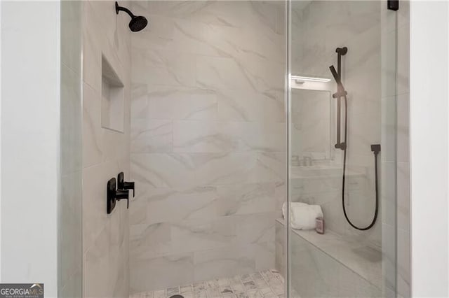 full bathroom with a marble finish shower