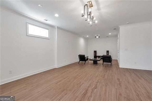 sitting room featuring visible vents, a chandelier, light wood-style flooring, and baseboards