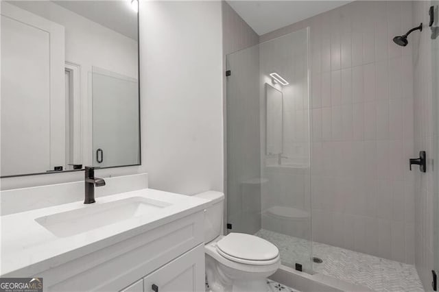 full bathroom featuring toilet, a shower stall, and vanity