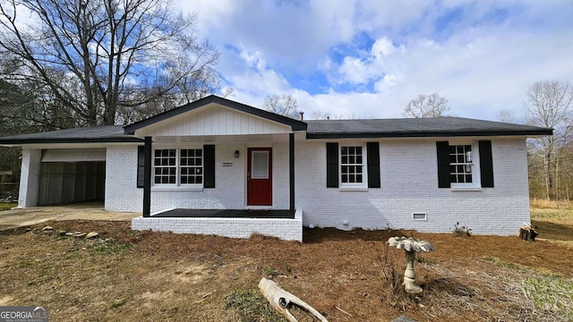 ranch-style home featuring covered porch, brick siding, crawl space, and a garage