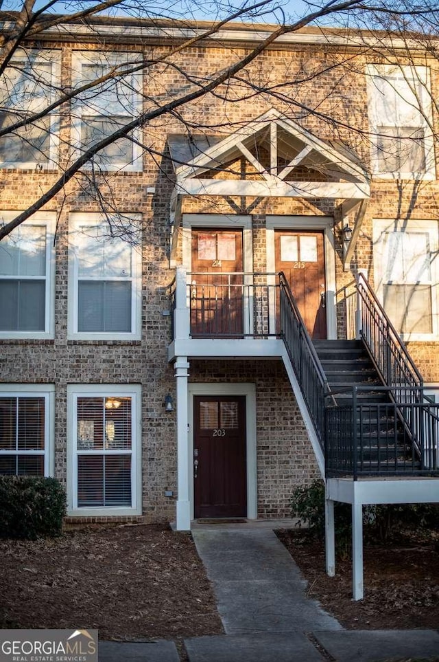 doorway to property featuring brick siding