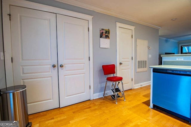 kitchen with baseboards, dishwashing machine, light wood finished floors, and crown molding