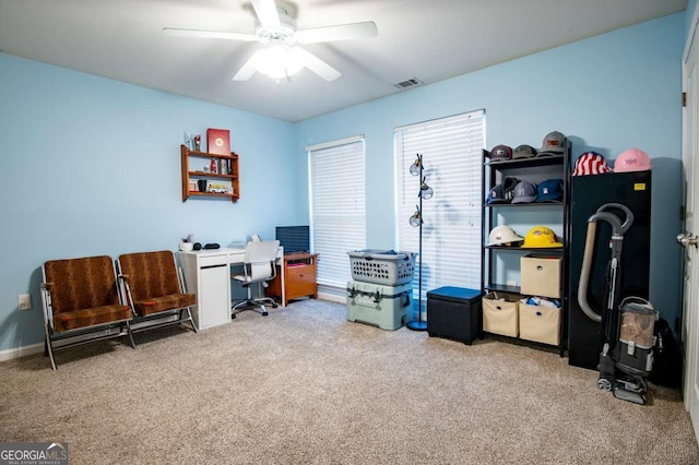 carpeted office with ceiling fan and visible vents