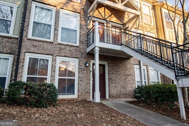 property entrance featuring brick siding