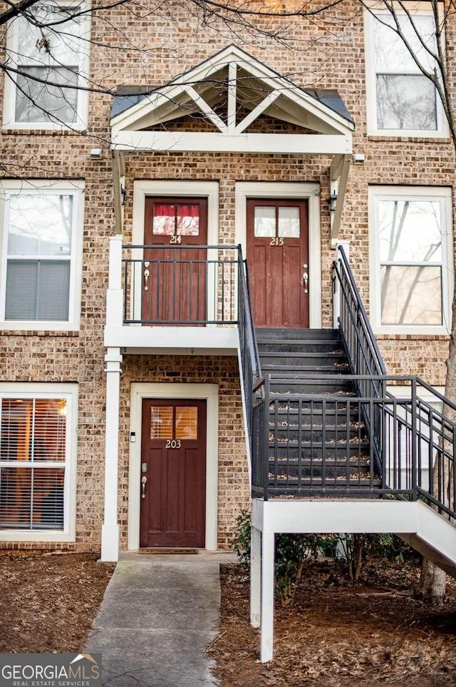 doorway to property with brick siding