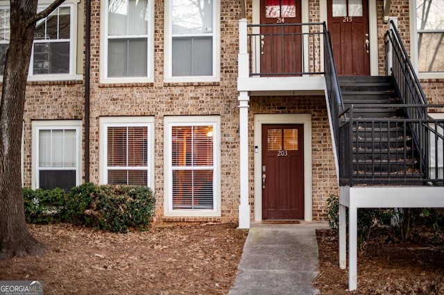 entrance to property featuring brick siding