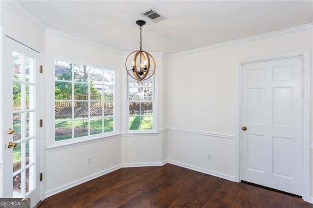 unfurnished dining area featuring baseboards, visible vents, dark wood-type flooring, crown molding, and a chandelier