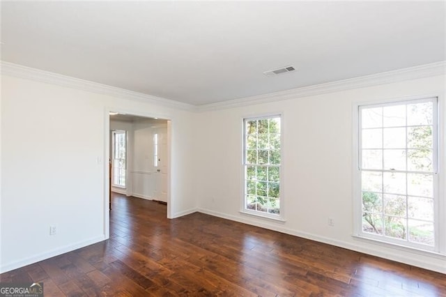 empty room with baseboards, ornamental molding, and dark wood finished floors