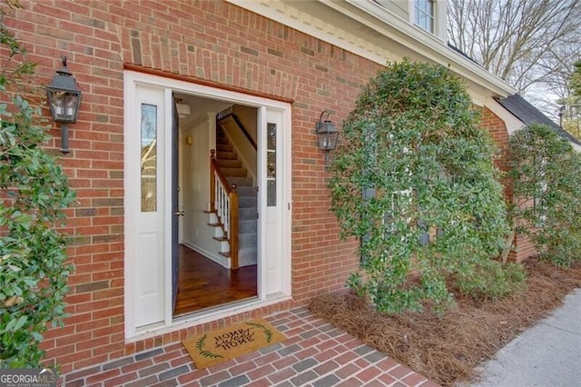 entrance to property featuring brick siding