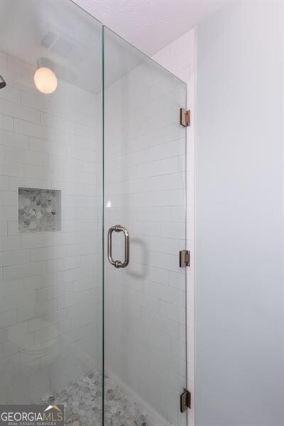 bathroom featuring a shower stall