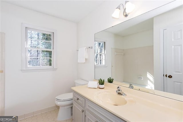 full bathroom with tile patterned flooring, vanity, toilet, and baseboards