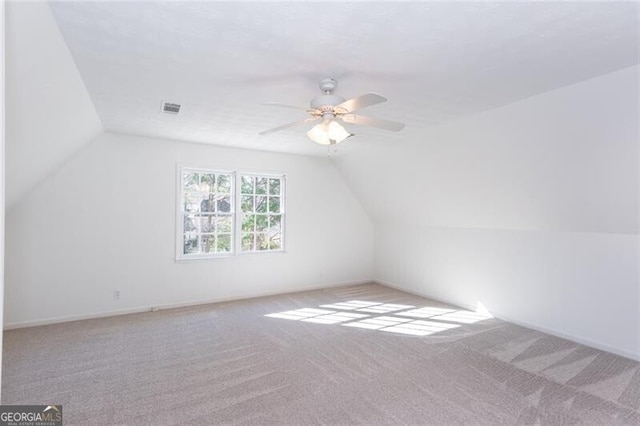 bonus room with visible vents, a ceiling fan, carpet flooring, vaulted ceiling, and baseboards