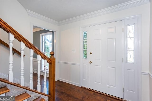 foyer entrance featuring dark wood-style flooring, crown molding, and stairs