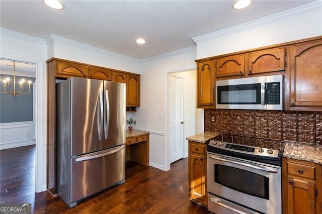 kitchen featuring appliances with stainless steel finishes, brown cabinetry, dark wood-type flooring, and tasteful backsplash