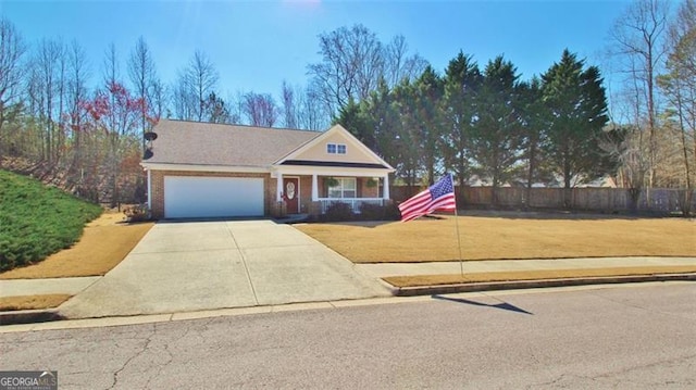 view of front facade featuring an attached garage, fence, driveway, and a front lawn