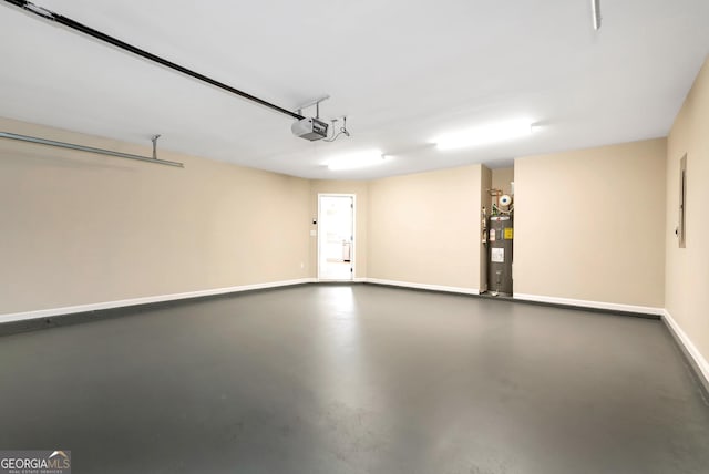 garage with baseboards, electric water heater, and a garage door opener