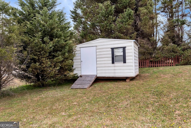 view of shed featuring fence