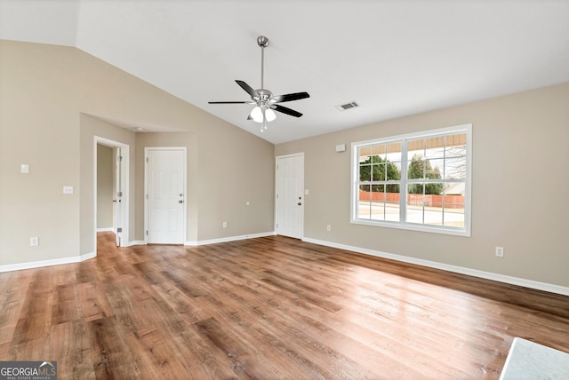 unfurnished living room featuring visible vents, vaulted ceiling, baseboards, and wood finished floors