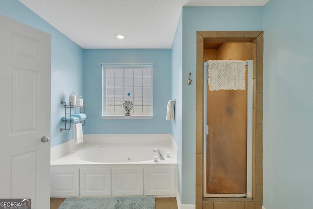 full bathroom with a stall shower and a tub with jets