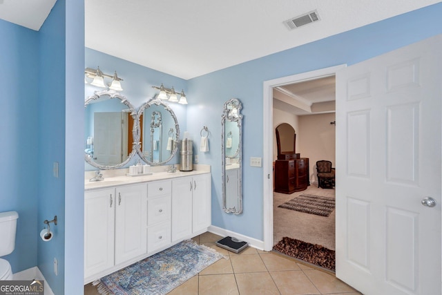 full bath featuring tile patterned flooring, double vanity, toilet, a sink, and visible vents