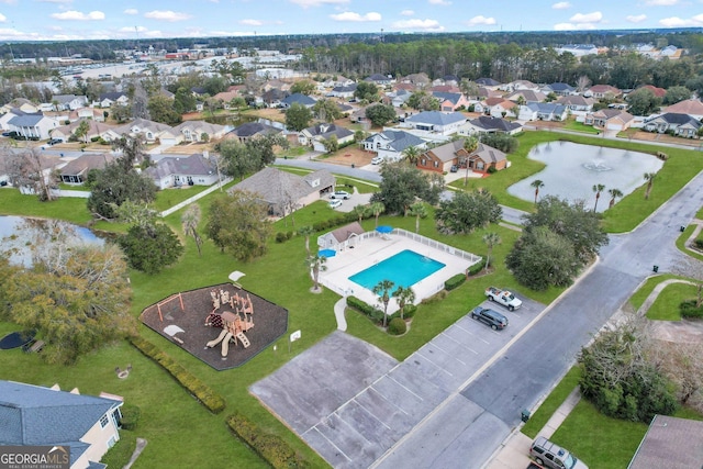 birds eye view of property with a residential view and a water view