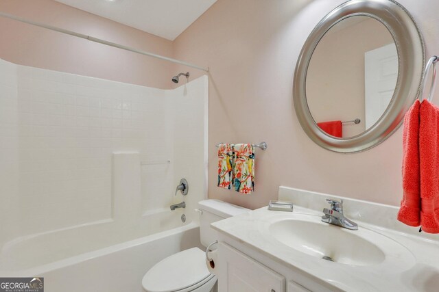 bathroom with washtub / shower combination, toilet, and vanity