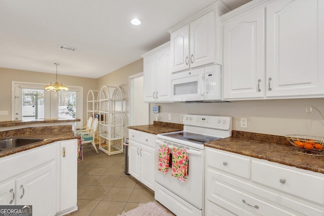 kitchen featuring light tile patterned floors, white appliances, visible vents, white cabinets, and dark countertops