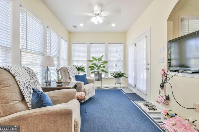 interior space with a ceiling fan, a wealth of natural light, and visible vents