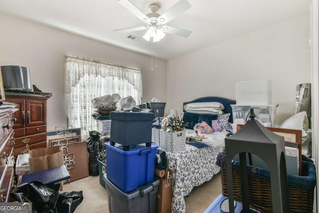 bedroom featuring ceiling fan, visible vents, and light colored carpet